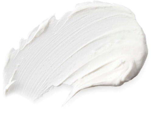 En hvit krem eller lotion som er spredd med et teksturert penselstrøk. Den ser myk og jevn ut.