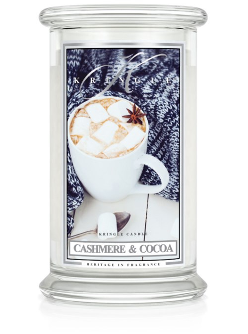 Ett doftljus med bild av en varm dryck med marshmallows, en stjärnanis och en mörk tygbakgrund. Texten är 'Cashmere & Cocoa' och 'Heritage in Fragrance'.