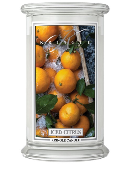 Ljuslykta med citrustemas, märkt 'Iced Citrus', med gula apelsiner och gröna blad.