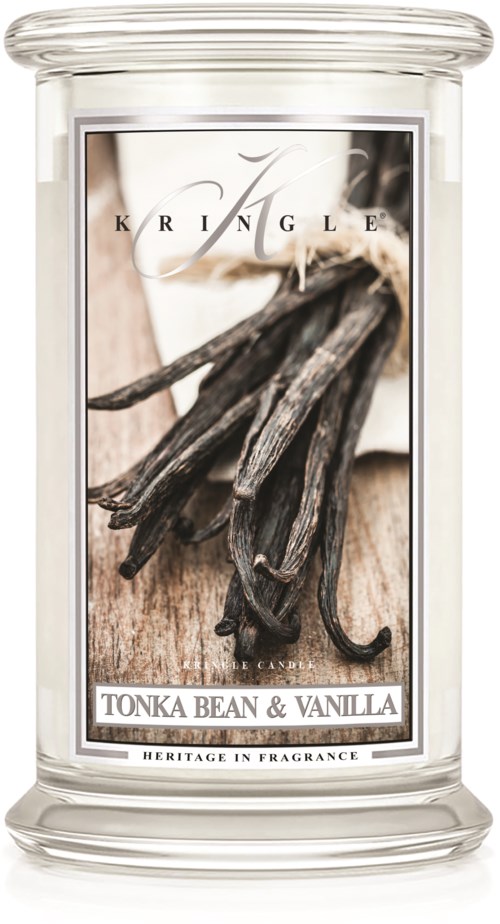En värmeljus med etikett som visar vanilj och tonkabönor, i ett glashållare. Etiketten säger "KIRINGLE" och "TONKA BEAN & VANILLA."