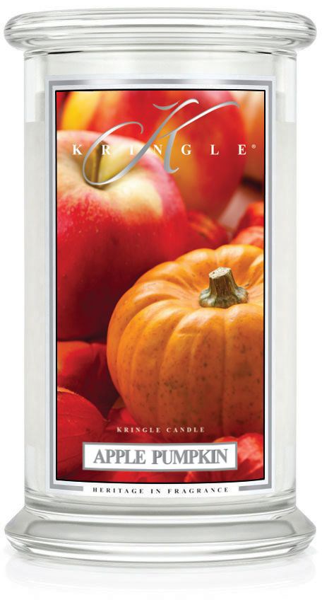 En tydlig glasljushållare med en etikett som visar äpplen och pumpor, märkta 'Apple Pumpkin' för doft.