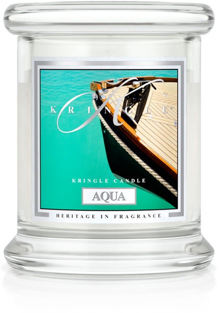 Ett tydligt glasljuslykta med en etikett av en båt på turkost vatten, märkt 'AQUA', och orden 'Kris' och 'Kringle Candle'.
