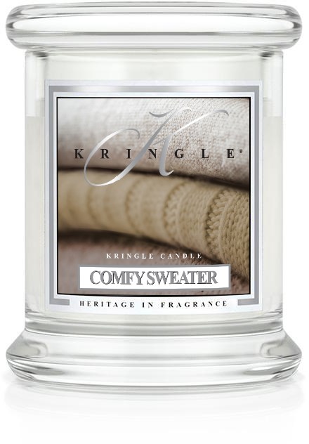 Ett tydligt glasljus med etikett som visar beige tröjor och namnet 'Comfy Sweater'.