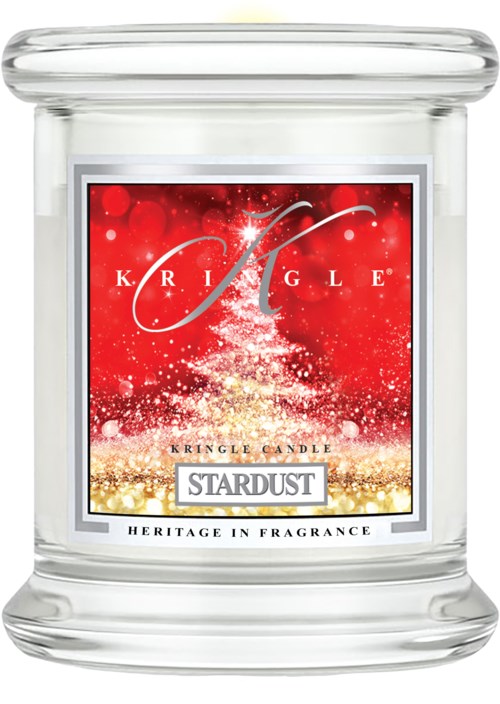 Ett tydligt glasljuskärl med en festlig röd, vit och guld etikett för Kringle Candles kallad Stardust.