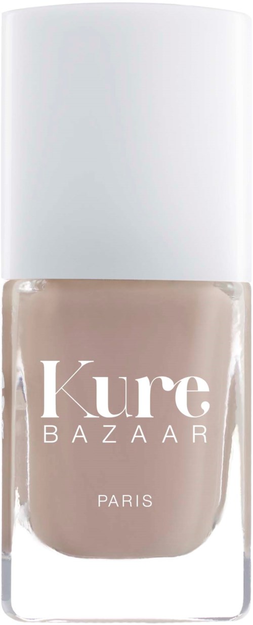 Ett nagellacksflaska i beige färg med vit lock, märkt 'Kure BAZAAR PARIS'.