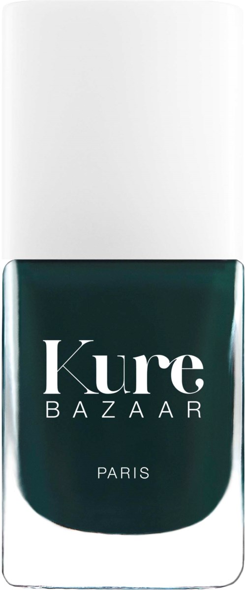 A nail polish bottle with a white cap and dark green polish. The bottle has the words 'Kure BAZAAR PARIS' on it.
