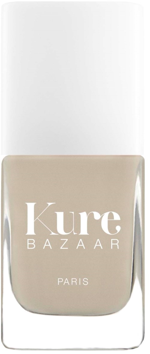 A beige nail polish bottle from Kure Bazaar with a white cap. The brand name and Paris are written on the bottle.