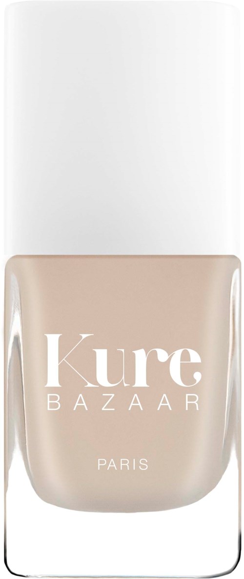 En flaske med beige neglelakk med hvit lokk og tydelig etikett som sier "Kure BAZAAR PARIS."