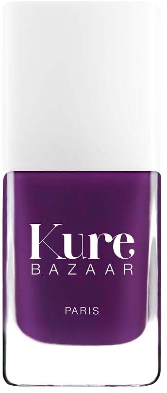 A purple nail polish bottle with white text reading 'Kure BAZAAR PARIS'.
