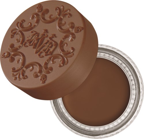 Ett runt behållare med ett dekorativt lock märkta "A&H," fyllt med brun grädde eller choklad.