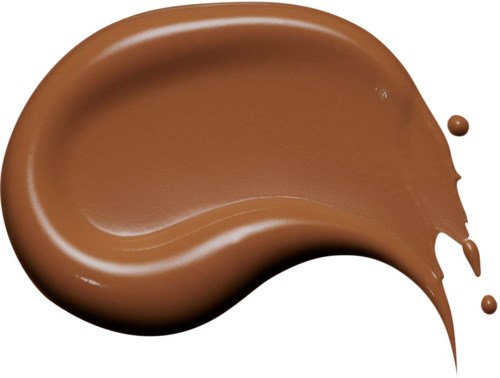 A swirl of melted milk chocolate with drips falling, on a black background.