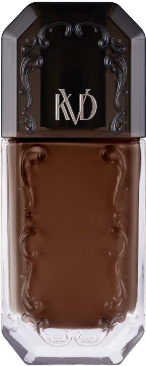 Eine lange, elegante braune Flüssigkeitsflasche mit einem schwarzen Deckel, der dekorative Details hat und die Buchstaben KVD trägt.