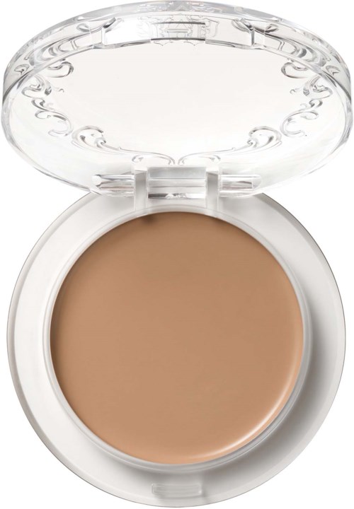 En liten eske med gjennomsiktig lokk som viser beige krem inni, brukt til sminke eller hudpleie.