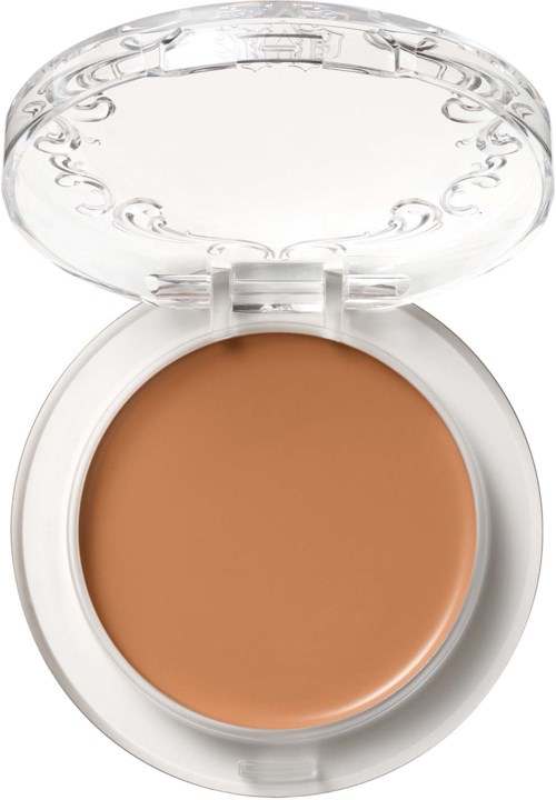 En liten burk med beige färgad kräm eller foundation, med klar plastlock öppet.