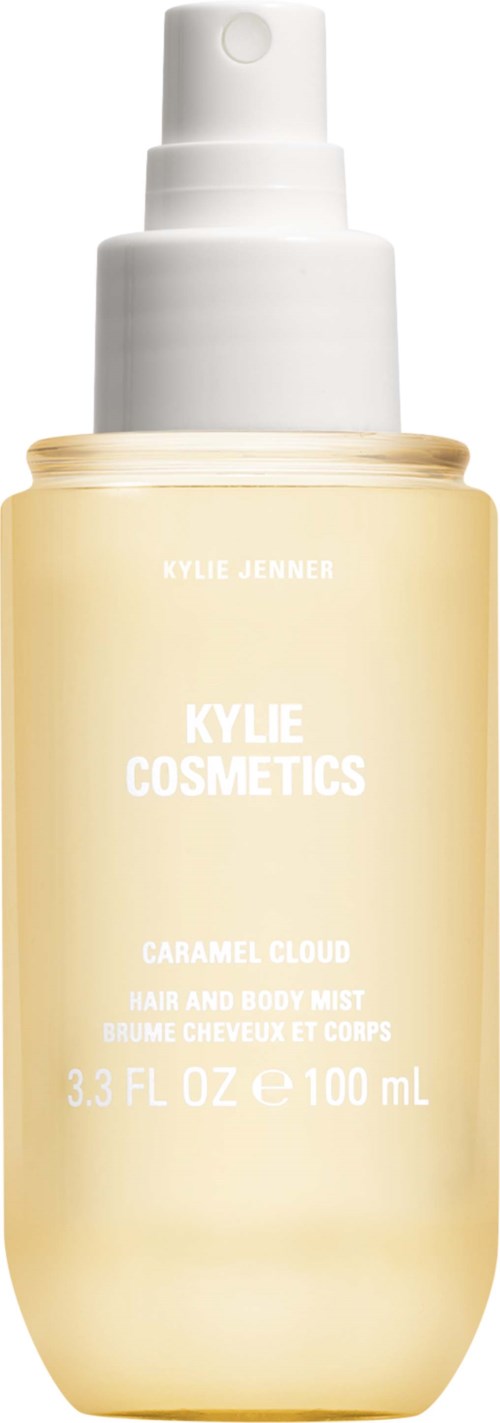 En lys gul sprayflaske med hvid pumpe og låg, mærket Kylie Cosmetics caramel cloud hår- og kropsmist, 3,3 fl oz.