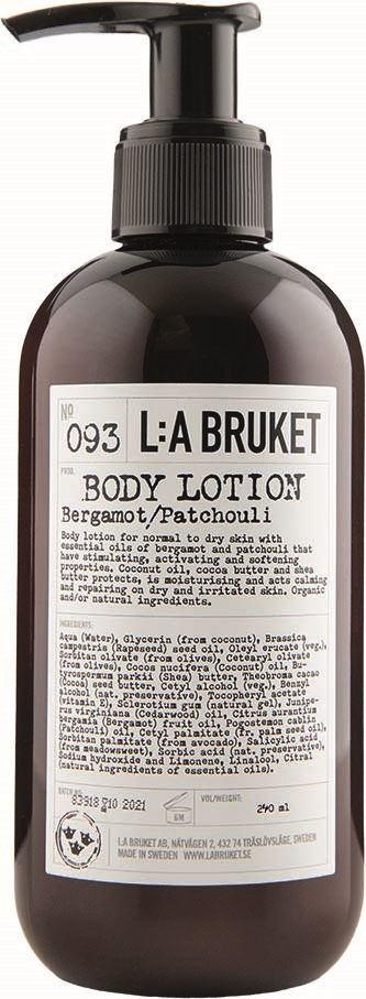 A dark bottle with a pump contains body lotion with bergamot and patchouli scent. The label shows product details and ingredients.