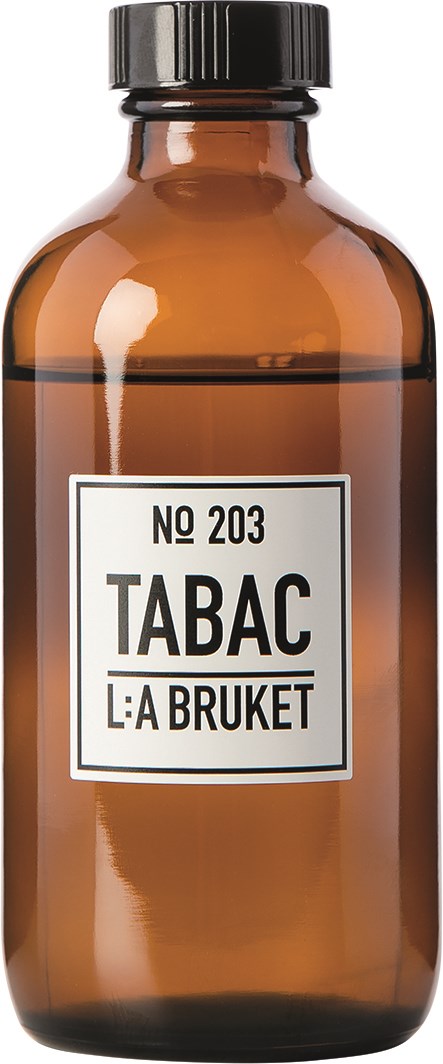 En brunt glasflaska märk2 med 'Tabac' och svart lock, enkel vit etikett och svart text.