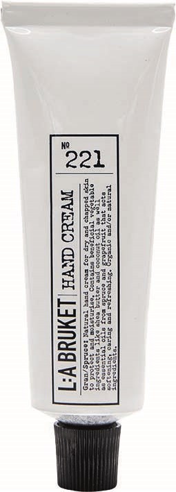 A white tube with black text labels it as hand cream, with a black cap on the bottom.