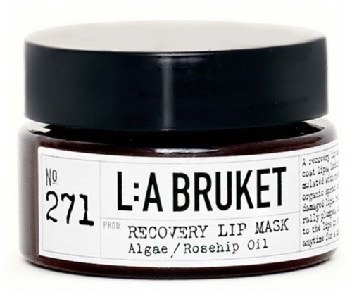 Small jar of lip mask with black lid, containing algae and rosehip oil. Labeled 'L:A BRUKET RECOVERY LIP MASK'.