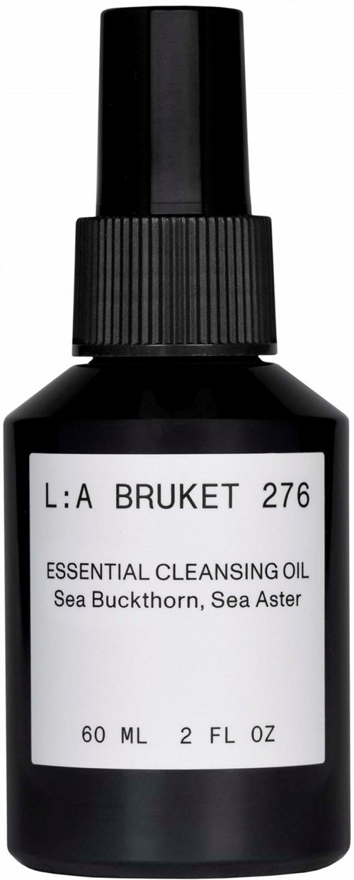 A small black bottle with a spray cap, labeled 'Essential Cleansing Oil' with sea buckthorn and sea aster ingredients.