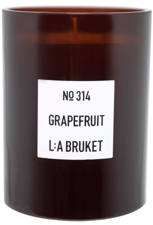 En mörkbrun lykta med vit etikett som visar grapefruktsmak och ett produktnamn på svenska.