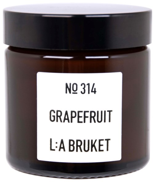 A small jar with a black lid, labeled 'Grapefruit' and 'L:A Bruket', likely a scented product.