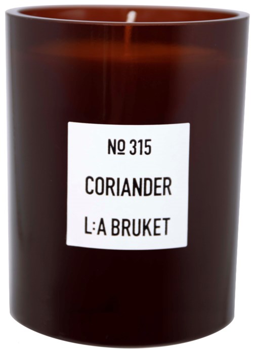 A brown candle jar with a white label reading 'No 315 Coriander L:A Bruket'.