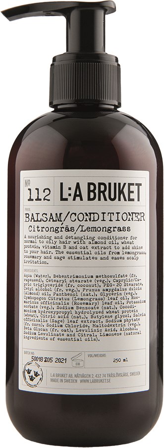 Czarna butelka z pompką, na etykiecie marka L:A BRUKE, wspomina balsam/odżywkę z zapachem trawy cytrynowej.