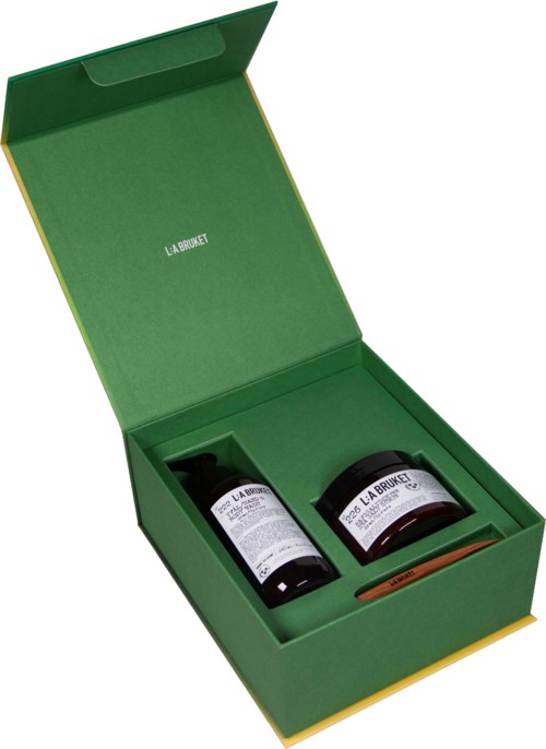 A green box contains two black bottles and a small stick, likely for health or beauty use.