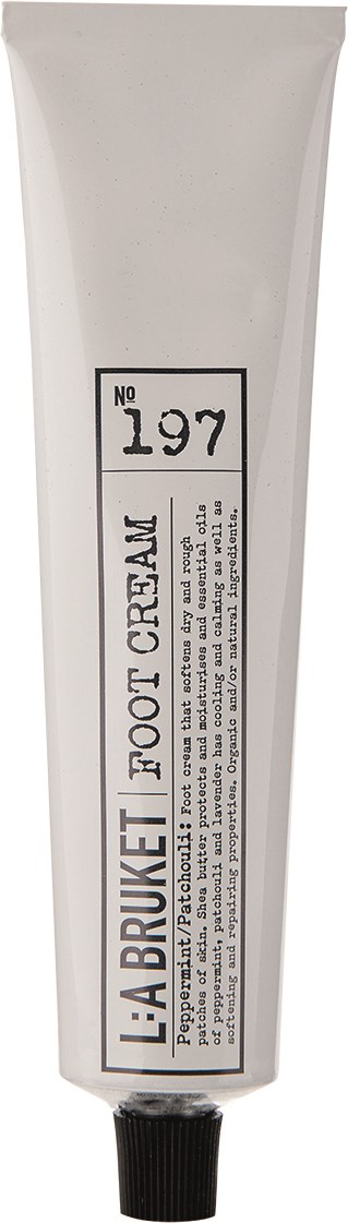 En vit tub med svart lock och en etikett som säger "L:A BRUKET FOOT CREAM No 197".