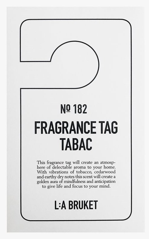 A fragrance tag labeled 'No 182', with scent description and brand name 'L:A BRUKET'.