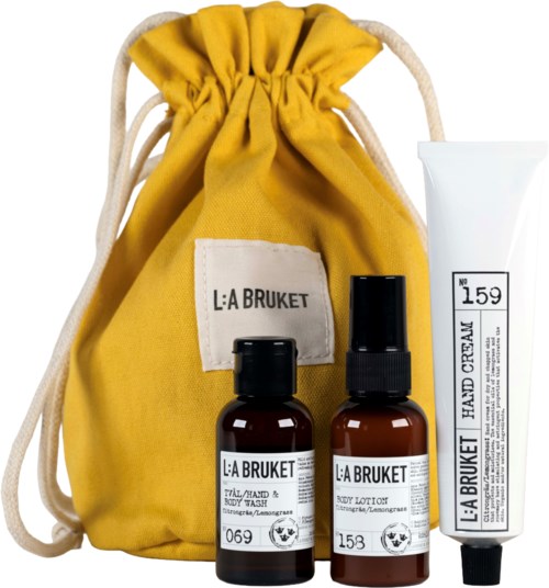 A yellow bag with two brown bottles and a white tube are displayed, with a label reading L:A BRUKET.