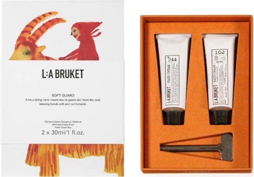 To tubes La Bruket hudpleje i en orange boks med en lille applikator.