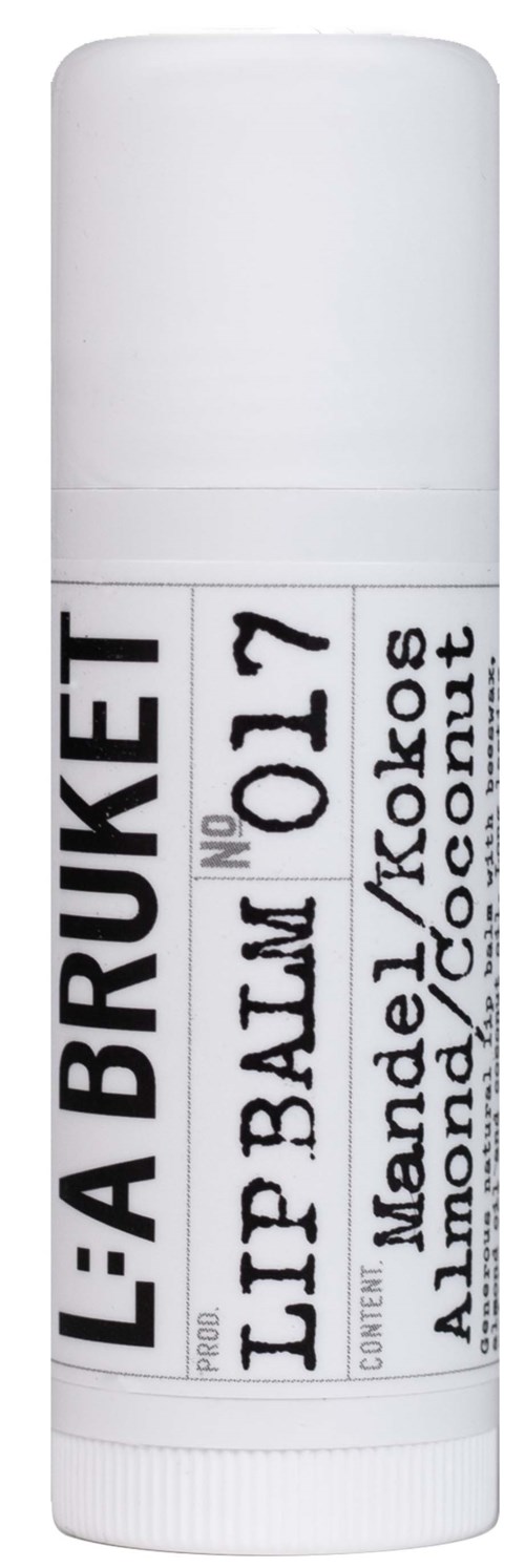Lip balm in a white tube labeled "L'A BRUKET" with flavor almond, coconut, and mandel.
