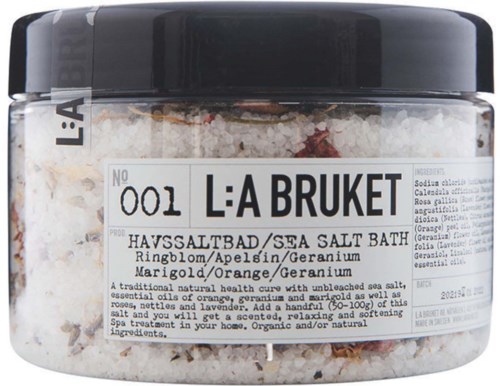 Ett havssaltbad med apelsin och geranium doft, liten burk med etikett som visar ingredienser och namn.