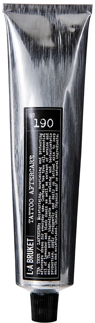Sølvfarvet tube med tattoo efterbehandling cremé med sort label og låg.