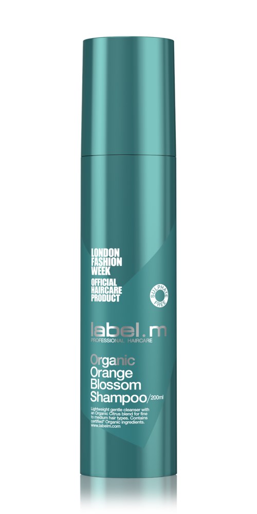 En tealfärgad flaska med organisk apelsinblomshampoo och vit text som nämner London Fashion Week och 200 ml storlek.