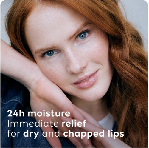 Close-up of a woman with red hair, promoting a skincare product for lips with 24-hour moisture and relief.