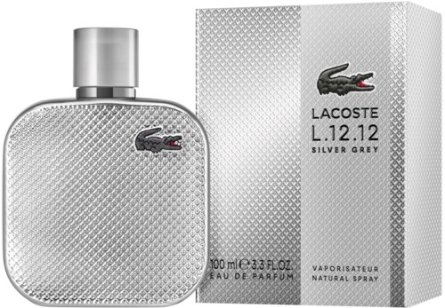 Silver grey perfume bottle with a textured surface and a Lacoste crocodile logo, next to a matching box.