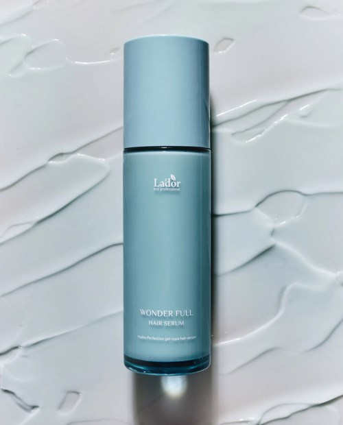 A light blue bottle labeled 'Wonder Full Hair Serum' on a white textured background.
