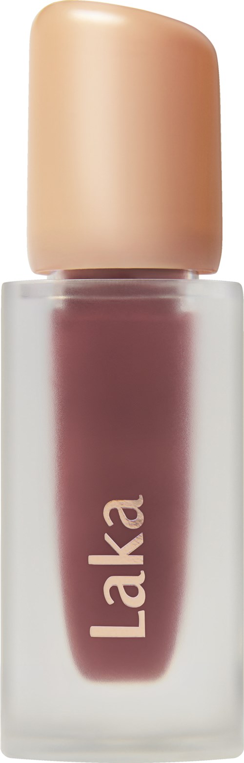 The image shows a nail polish bottle with a beige cap and pinkish color liquid inside. The brand name 'Laka' is on the bottle.