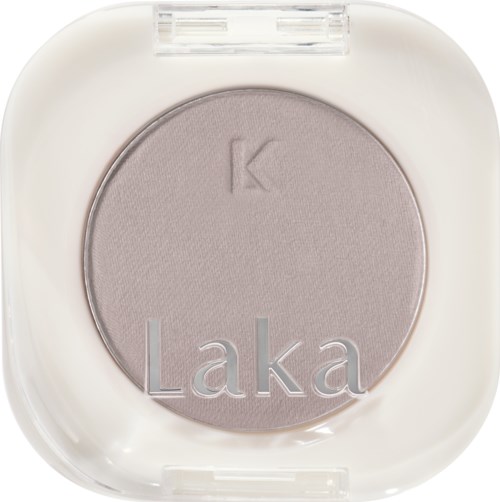 En rund lys lilla øyeskygge i et hvitt tilfelle, med ordene "Laka" og "K" preget.