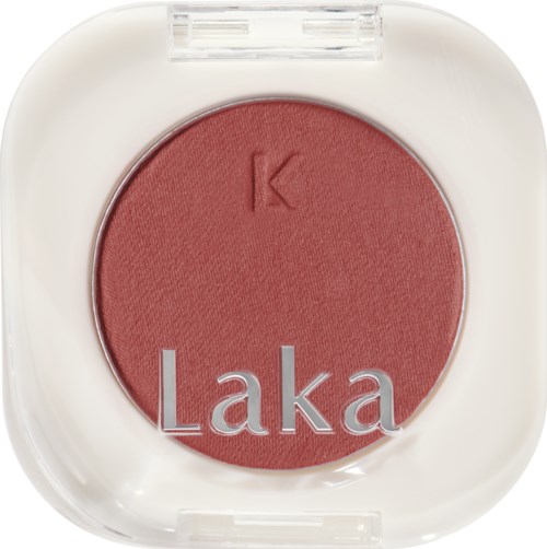 En rund blush-kontakt med bokstav 'K' og ordet 'Laka' på.