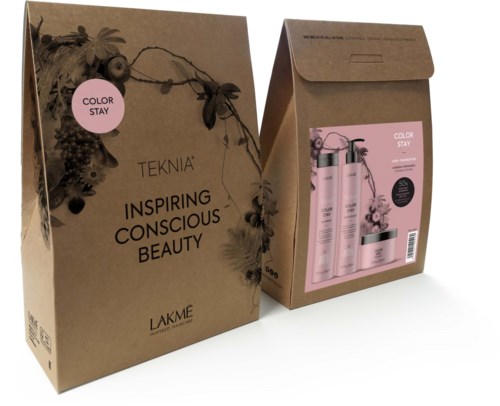 A brown paper bag with pink design and text, holding beauty products and a leaflet inside. The bag says "Inspiring Conscious Beauty".