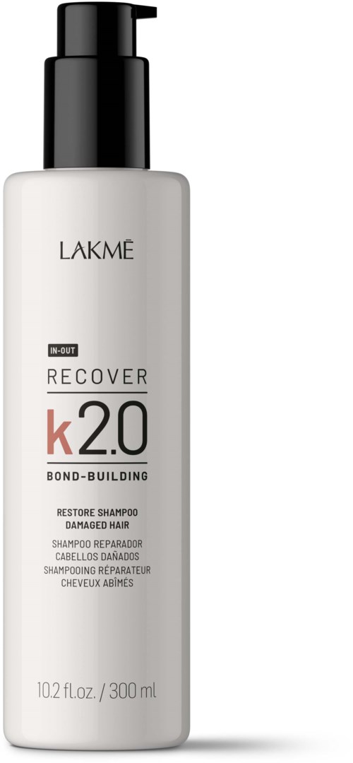 Biała butelka z czarnym dozownikiem, oznaczona Lakme, do naprawy uszkodzonych włosów. Napis 'Recover K2.0' i pojemność 300 ml.