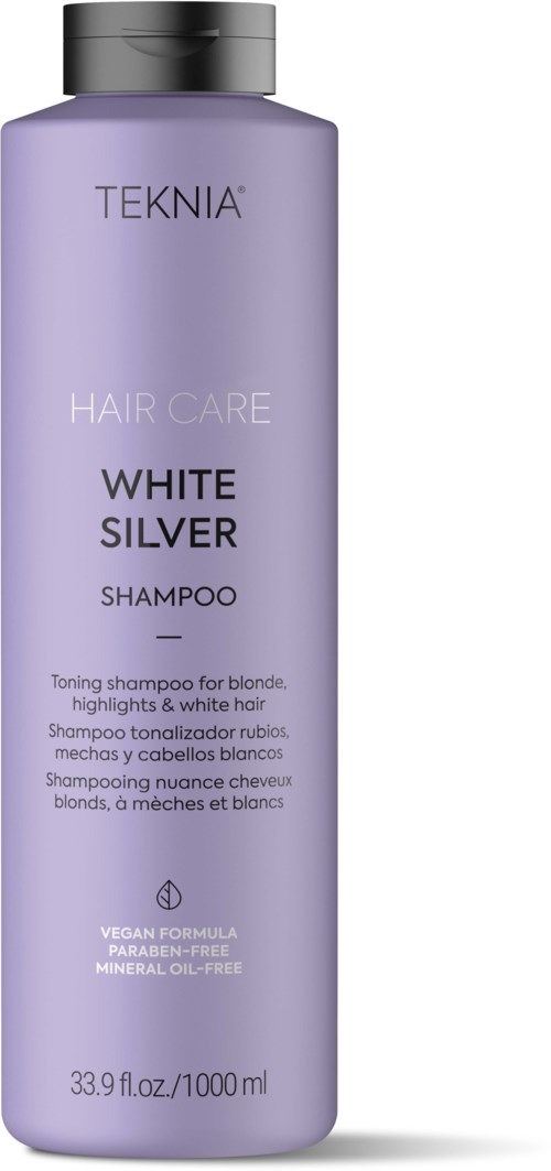 A tall, lavender shampoo bottle labeled TEKNIA, for blondes, with white words about hair care and vegan formula.