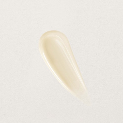 Eine kleine Menge weiße Creme auf einfachem Hintergrund.