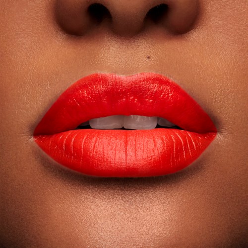 Close-up of lips with bright red lipstick, slightly parted showing teeth.