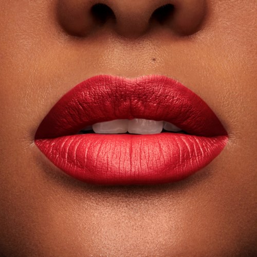 Close-up of lips with bright red lipstick, slightly open showing teeth, skin tone around lips visible.