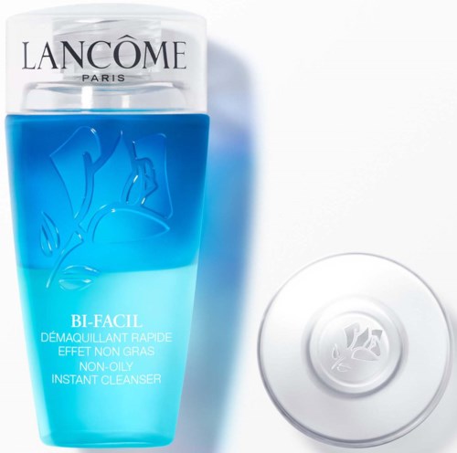 En blå och klar flaska med vit kork och en rund tvål, med Lancôme-logga och produktinformation.